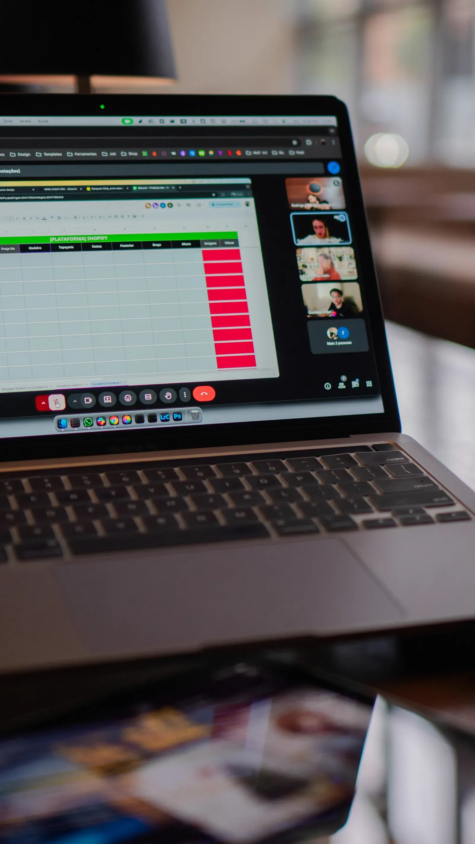 Laptop screen displaying a video conference window alongside a spreadsheet, capturing a working discovery call.