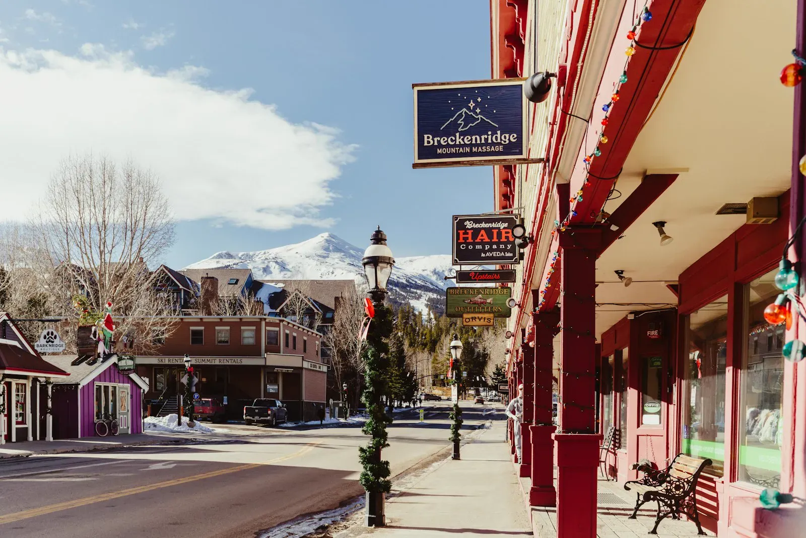 Street view of a charming mountain town with several local shops lining the main commercial street.