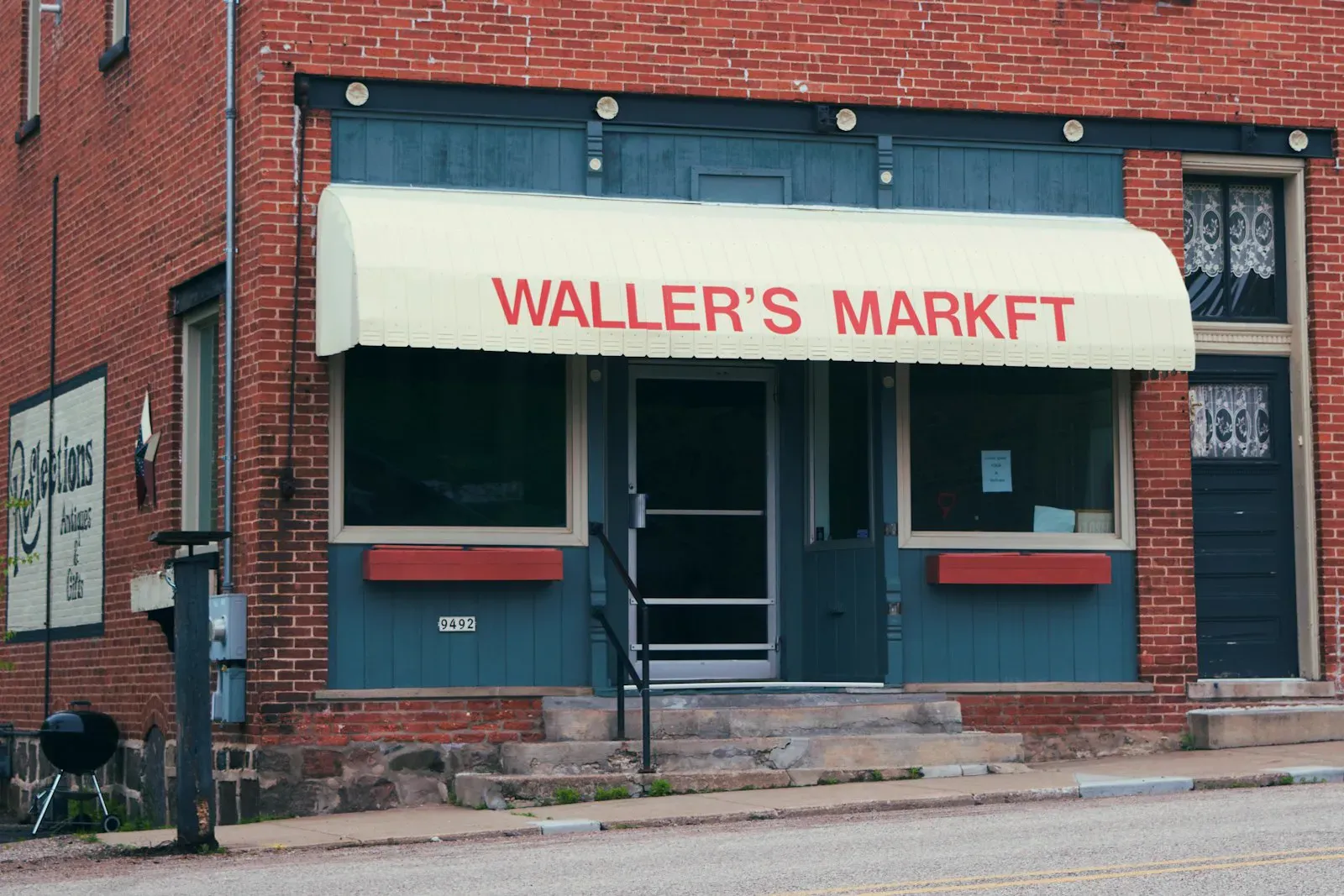 A brick local market storefront on a small-town street, the kind of independent business that lives or dies by local search visibility.