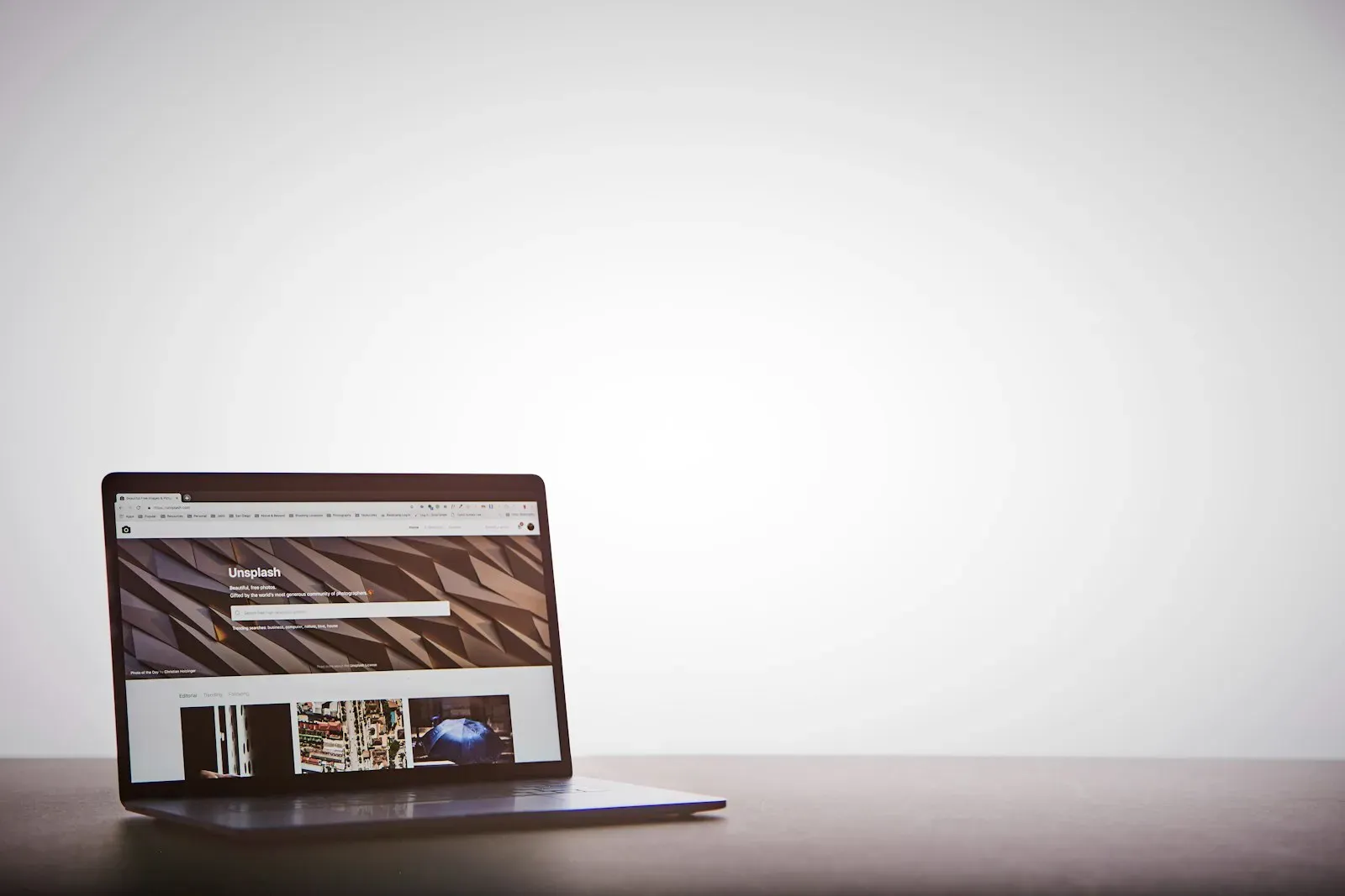 An open MacBook Pro on a clean desk with a webpage visible on the screen, a workspace ready for landing-page conversion work.