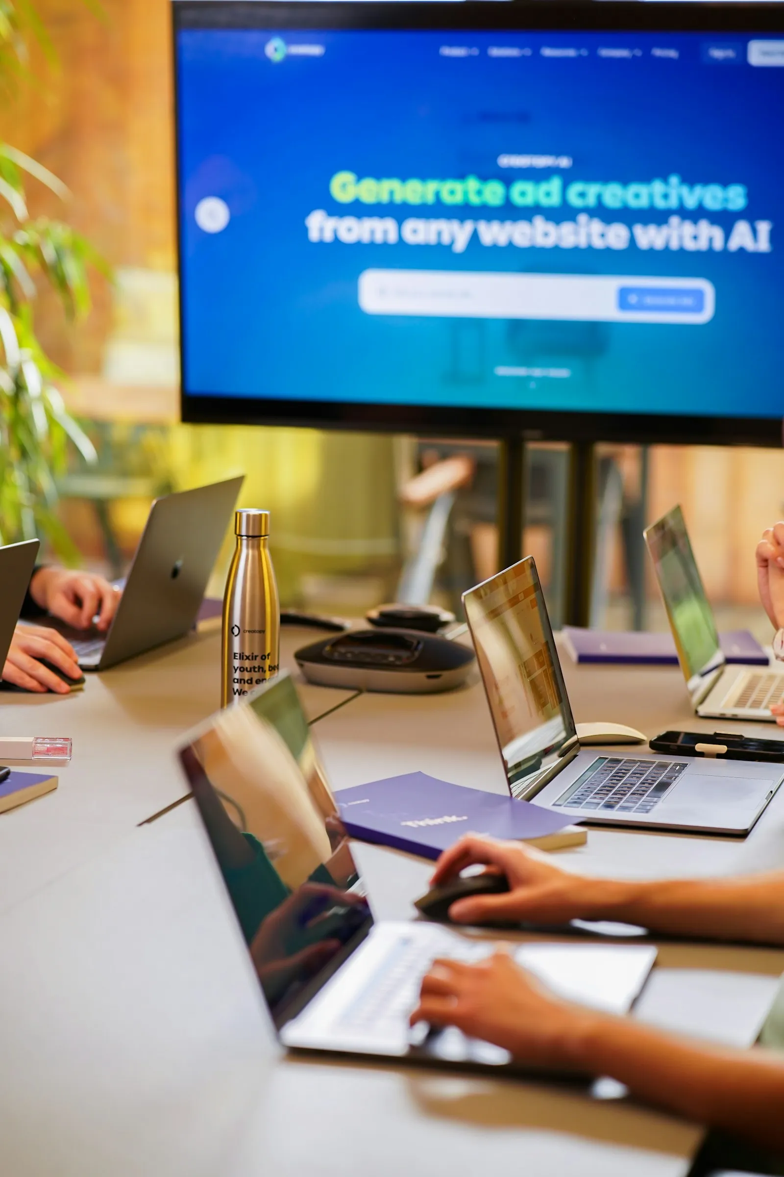 A small team collaborating around a table with laptops, the kind of working session a Phoenix marketing agency runs with a client in the first month of engagement.