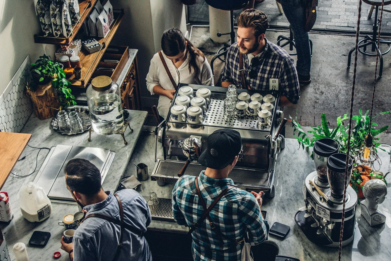 Customer being served at a busy coffee shop counter, a typical small business in action.