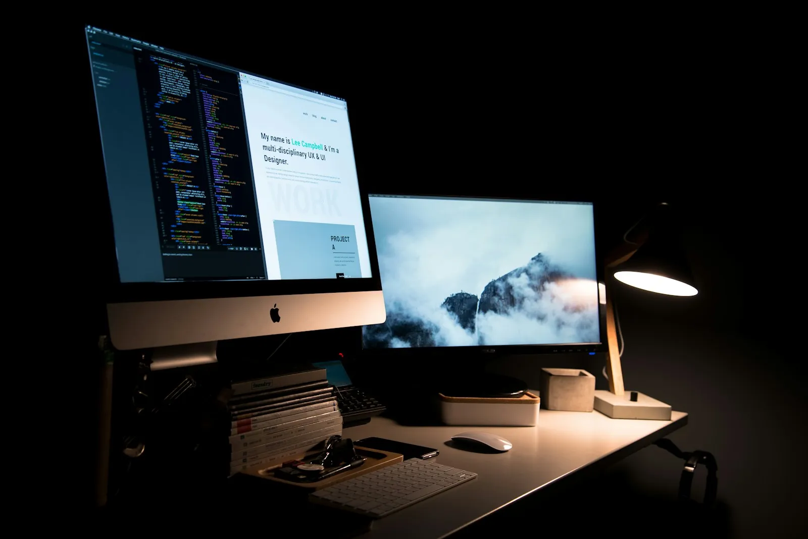 Open laptop on a wooden desk with a website draft visible on screen.