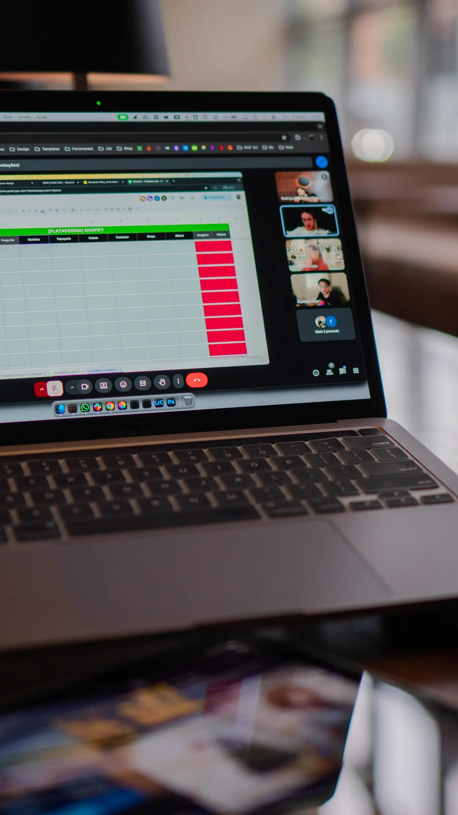 Laptop screen displaying a video conference window alongside a spreadsheet, capturing a working discovery call.